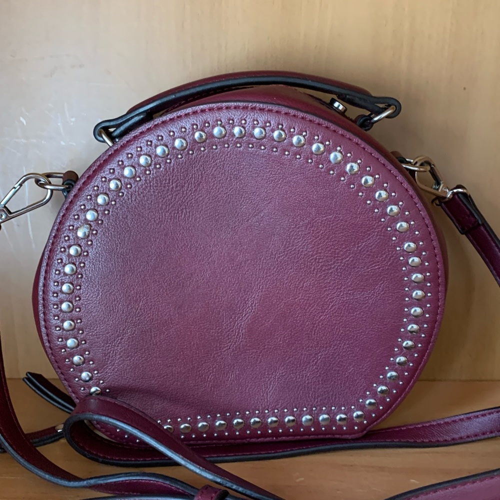 Inc crossbody. Color is wine.  Never used.
